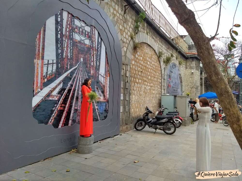 Dos chicas haciéndose fotos en los murales de Hanoi